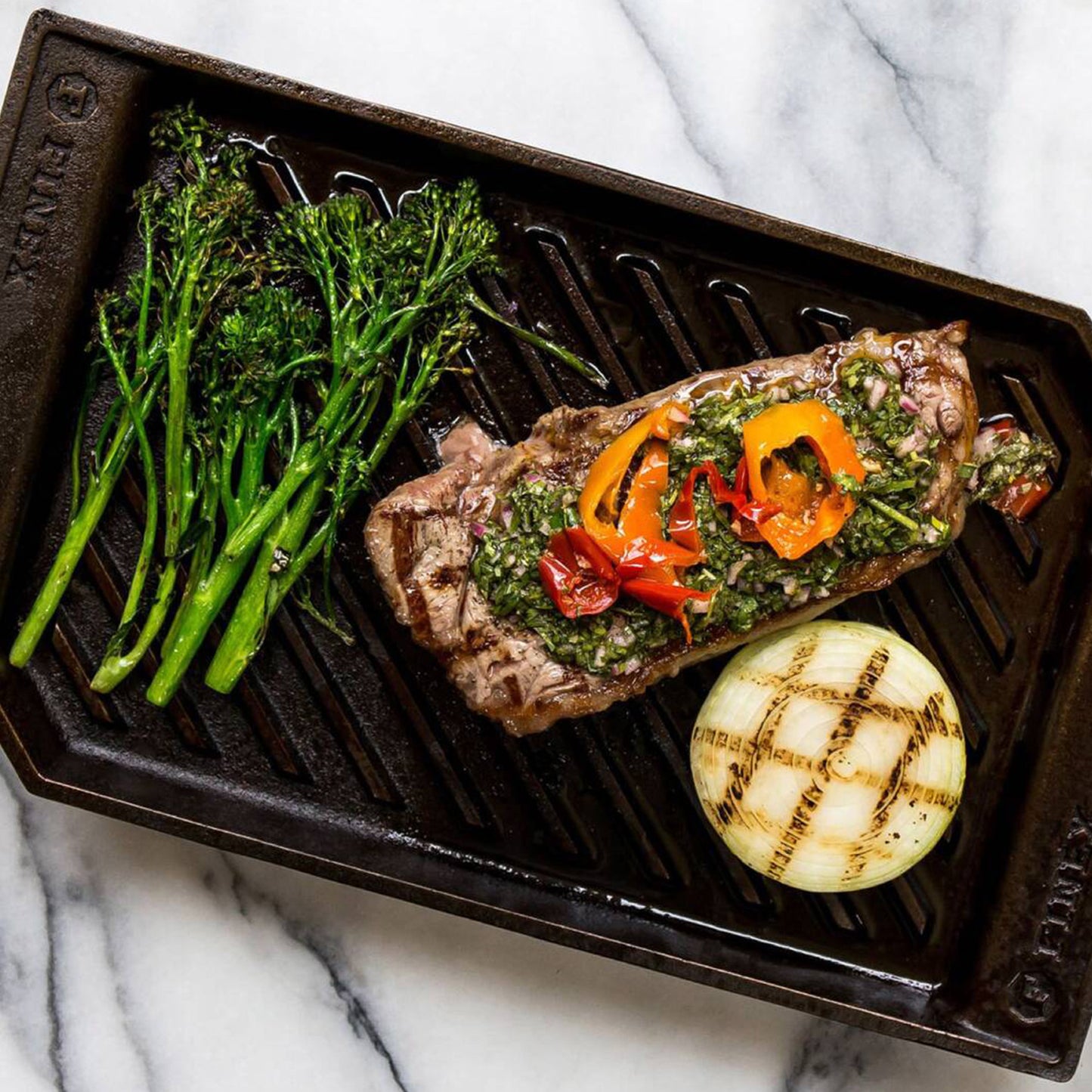 cooked steak with broccolini and onion