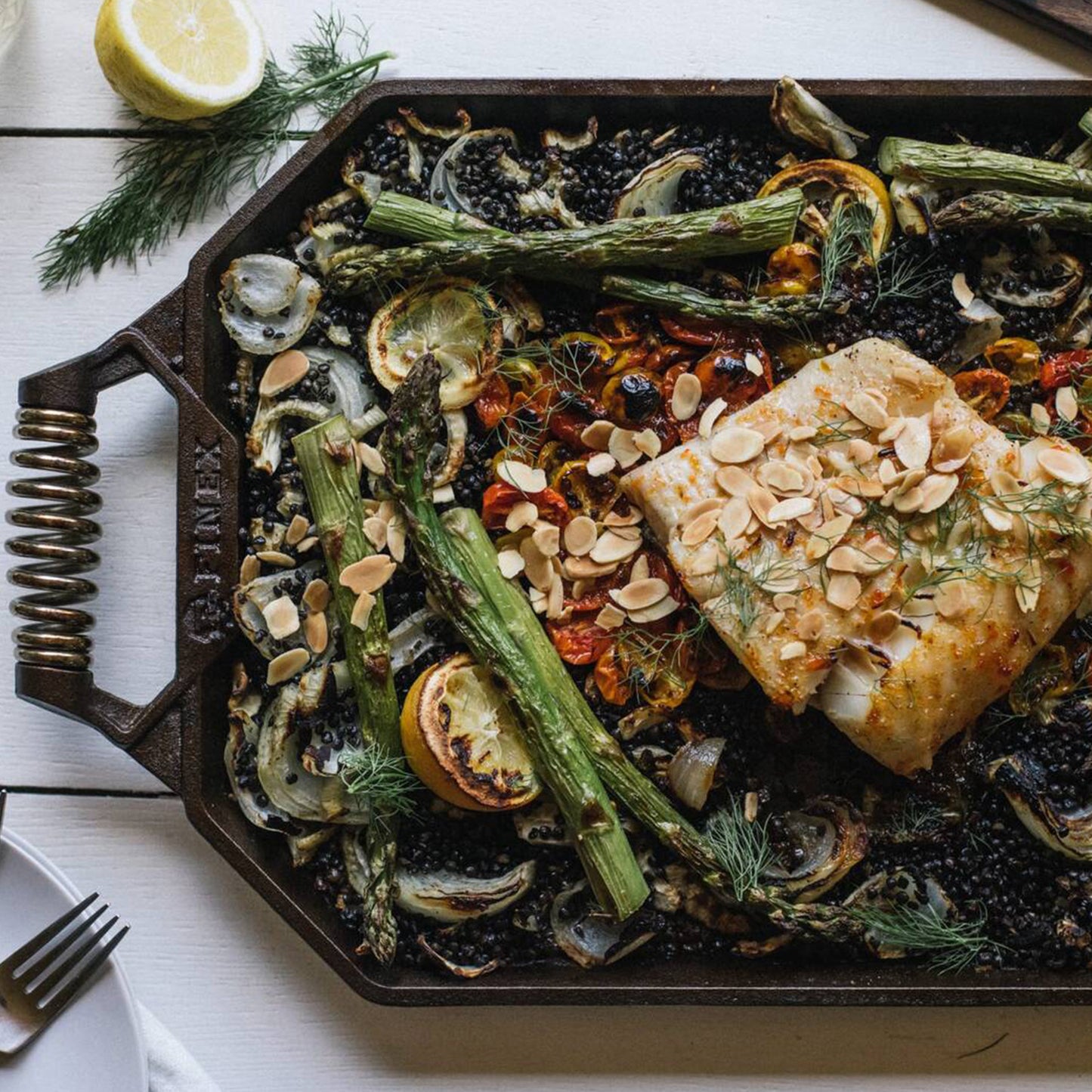 Assorted cooked vegetables and fish on a finex griddle