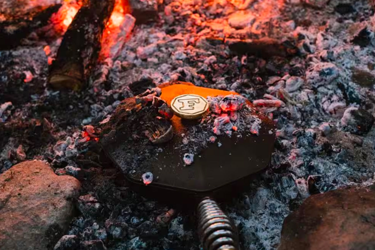 Finex skillet cooking outdoors over firewood